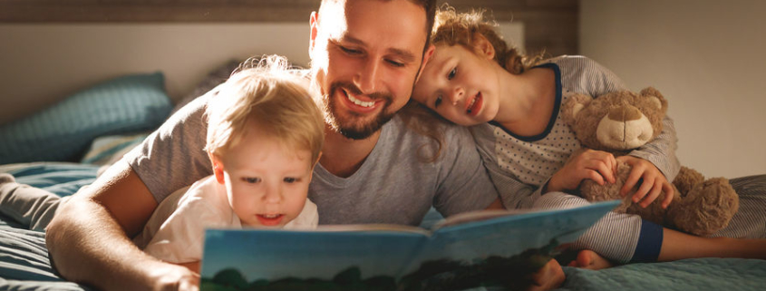 Father reading to kids before bed