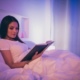 woman reading in bed before bedtime