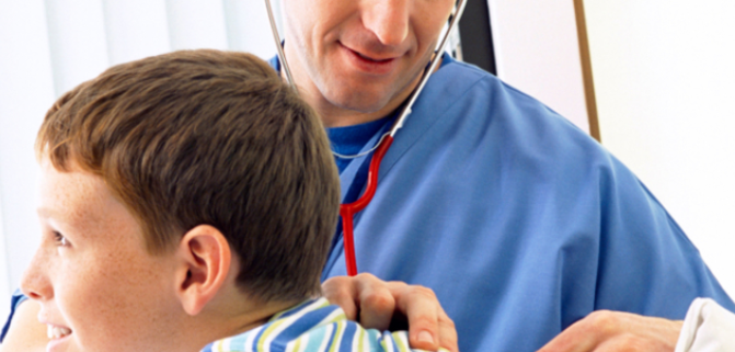 Doctor examining boy