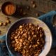 Spicy roasted pumpkin seeds in bowl on table