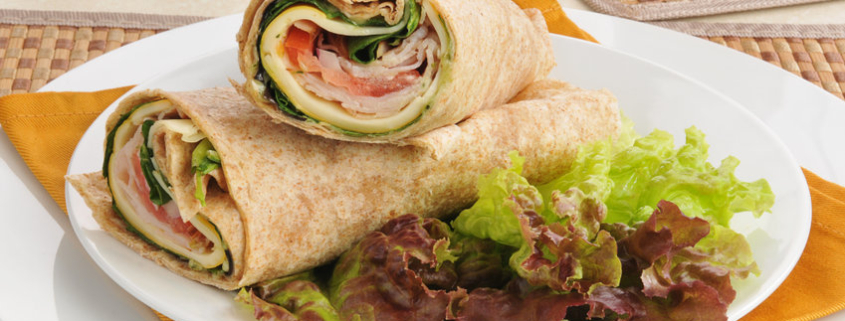 Smoked turkey and cheese wraps on lettuce