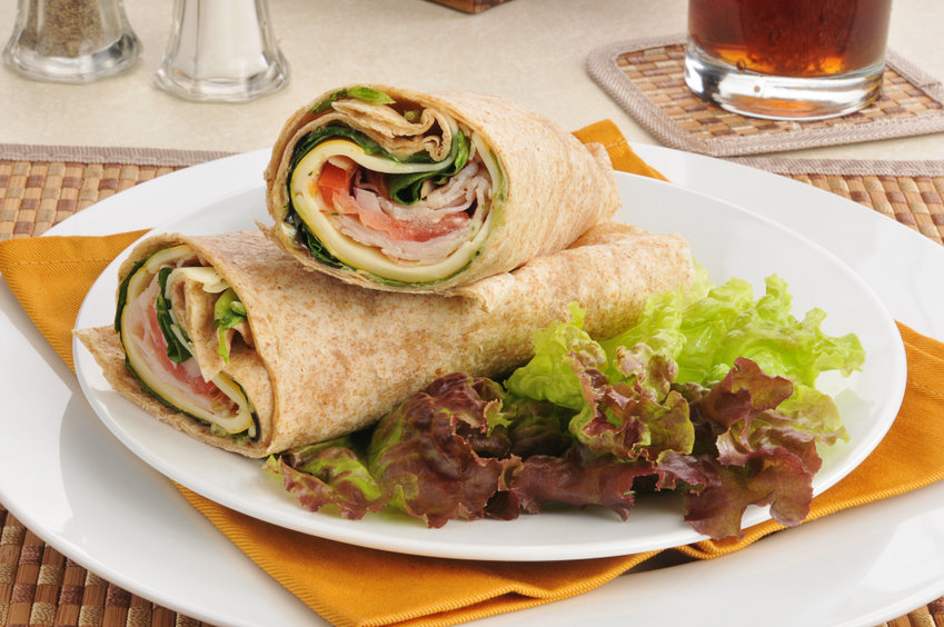 Smoked turkey and cheese wraps on lettuce