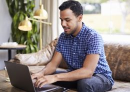 young-man-sitting-in-a-coffee-shop-using-computer