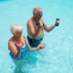 man and woman exercising in the pool