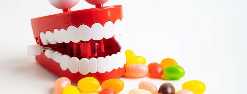 candy alongside a dental mouth with eyes